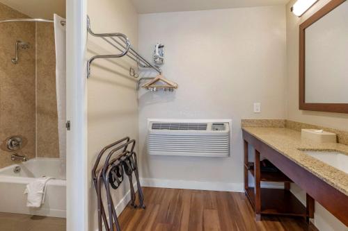 a bathroom with a sink and a bath tub at Comfort Inn Bishop in Bishop