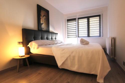 a bedroom with a large bed and a window at Danny and Linda Flat in La Massana
