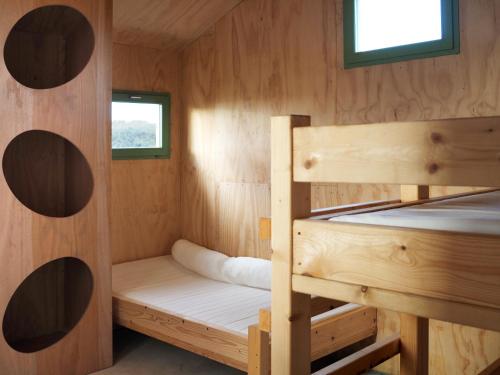 a wooden cabin with two bunk beds in it at Les Refuges de Mer in Petit Port