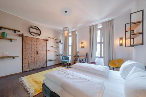 a bedroom with two beds and a table and a chair at Design Apartments - "Heiliger See" in Potsdam