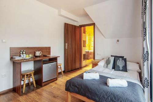 a bedroom with a bed and a desk in it at Apartamenty Majerczyk in Zakopane