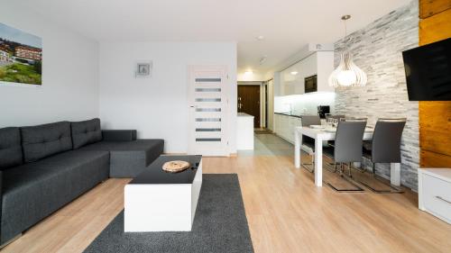 a living room with a couch and a table at Triventi Mountain Residence, Sun & Snow in Karpacz
