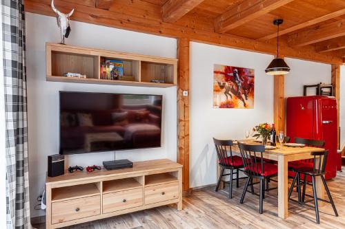 a dining room with a table and a large television at Ferienwohnung Wild West in Eging am See