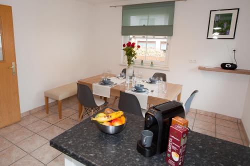 a kitchen with a table with a bowl of fruit on a counter at Apart Plangger in Nauders