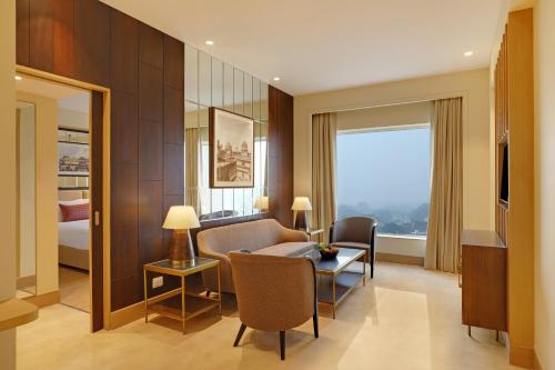占西Lemon Tree Hotel, Jhansi的带沙发和桌子的客厅