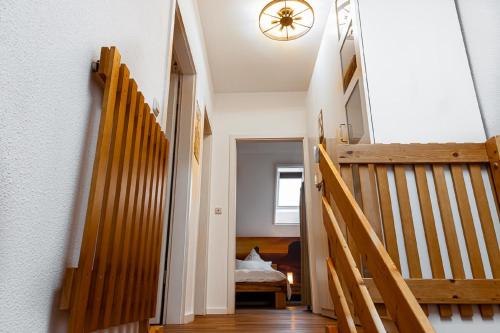 a hallway with wooden stairs and a stair case at Ferienwohnung Wild West in Eging am See
