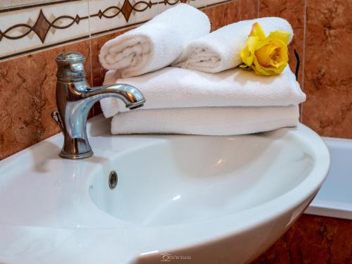 a bathroom sink with towels and a faucet at Alla Basilica Rooms in Rome