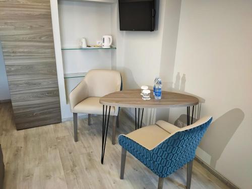 a table and two chairs and a table and chairs at Abbaye des Capucins Spa & Resort in Montauban