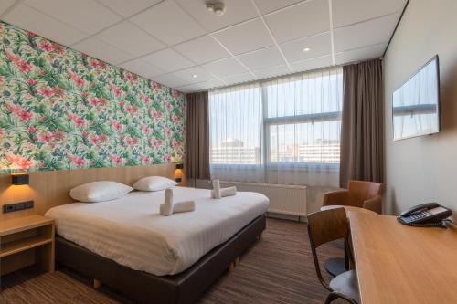 a hotel room with a bed and a wall mural at Best Western Amsterdam in Amsterdam