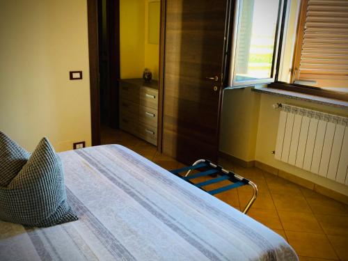 a bedroom with a large bed and a window at Agriturismo Cascina Mariale in Albiano dʼIvrea