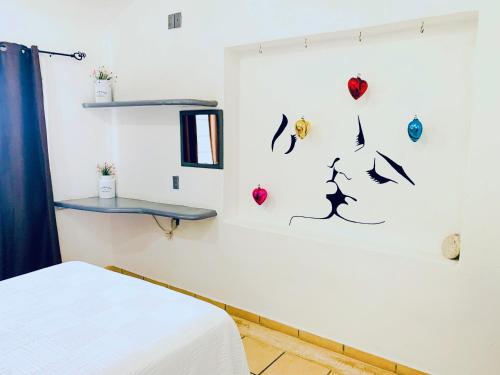a room with a bed and some decorations on the wall at Habitaciones Samy in San Francisco