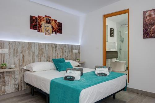 a bedroom with a bed with two bags on it at Villa Mamba By Seric,15' walking to the beach in Torremolinos