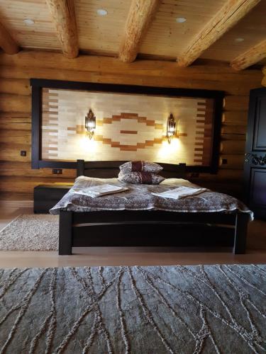 a bedroom with a bed in a wooden room at Hotel Ashad in Svalyava