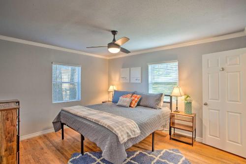 a bedroom with a bed and a ceiling fan at Dock and Fire Pit Lakefront Cedar Creek Home! in Mabank