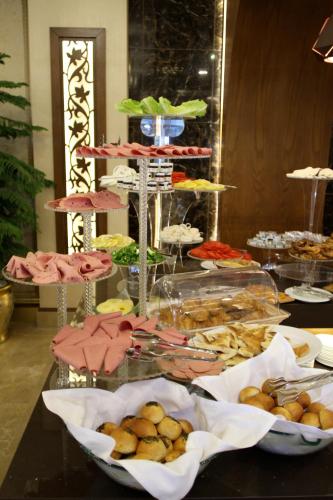 a table topped with lots of different types of food at Ankawa Royal Hotel & Spa in Erbil