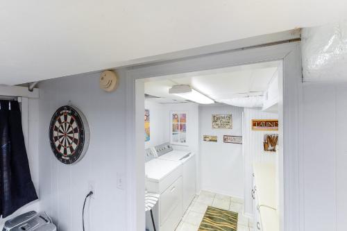 a white bathroom with a dartboard on the wall at A Precious Place in Gatlinburg