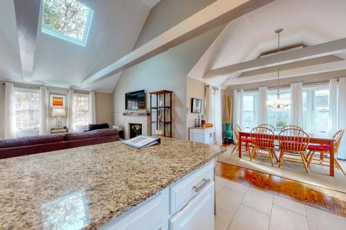 a kitchen and living room with a table and chairs at Sit Back & Relax in Eastham