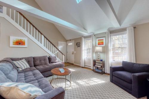 a living room with a couch and a table at Sit Back & Relax in Eastham