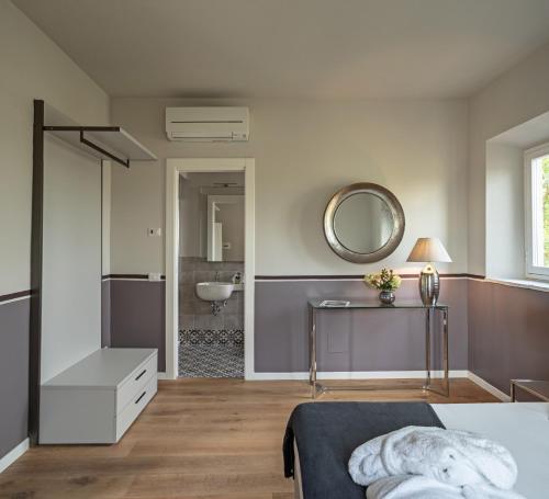 a bedroom with a bed and a sink and a mirror at Podere GIUSTI in Reggello