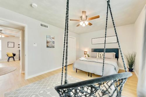 a bedroom with a swinging bed and a ceiling fan at The Dallas Vibe and Free Arboretum Tickets in Dallas