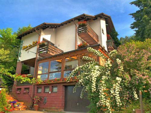 una casa con balcones y flores. en Gästehaus Heller, en Elmstein