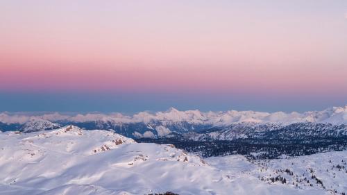 a view of a snowy mountain range with snow covered mountains at Apartment Brigitte in Obertraun
