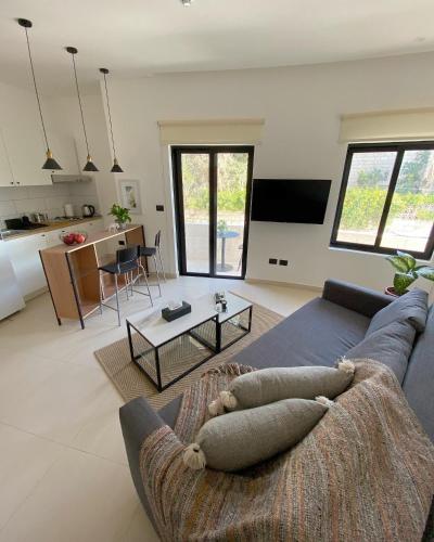 a living room with a couch and a table at Nu Fifty Two in Amman