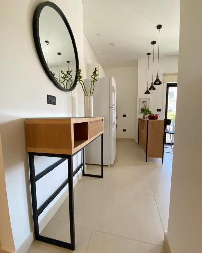 a room with a table and a mirror on the wall at Nu Fifty Two in Amman