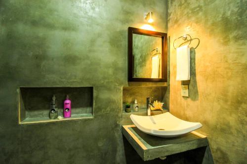 a bathroom with a sink and a mirror at Casa de Olas Boutique Hotel in Puerto Escondido
