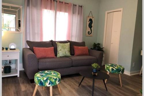 a living room with a couch and two tables at The Comfi Coral - 2 Bed Apartment Home Studio B in Baytown