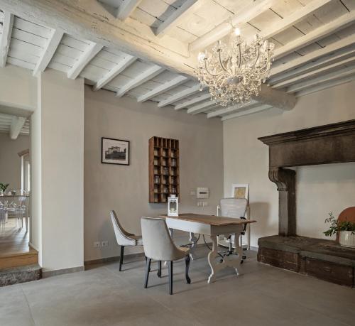 a dining room with a table and chairs and a chandelier at Podere GIUSTI in Reggello
