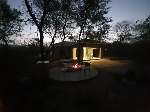a small house with a fire in front of it at 3714 @Ribbok in Marloth Park