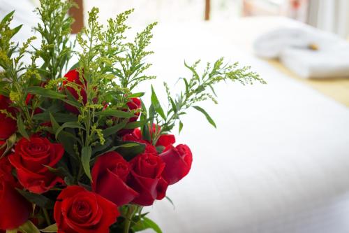 a bouquet of red roses in a vase at Ilalo Garden Hotel & Restaurant in Quito