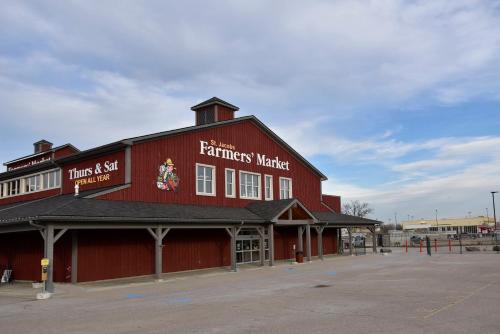 a red barn with a farmers market sign on it at Staybridge Suites - Waterloo - St. Jacobs Area in Waterloo