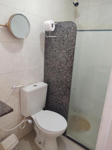 a bathroom with a toilet and a shower and a mirror at Hotel Portal Do Mar in Conde