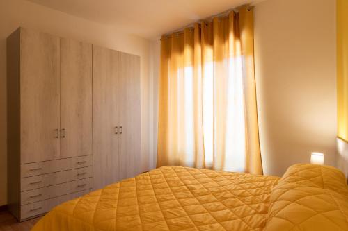 a bedroom with a bed and a dresser and a window at Les 2 Soeurs in Pont-Saint-Martin