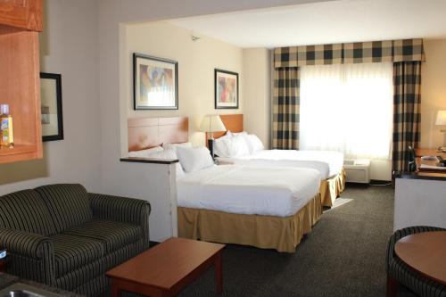 a hotel room with two beds and a couch at Holiday Inn Express Hotel Vernal by IHG in Vernal