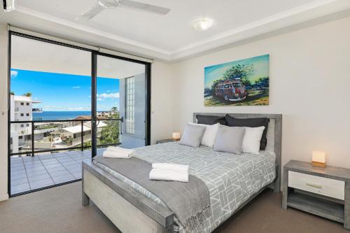 a bedroom with a bed and a view of the ocean at Mariners Resort Kings Beach in Caloundra