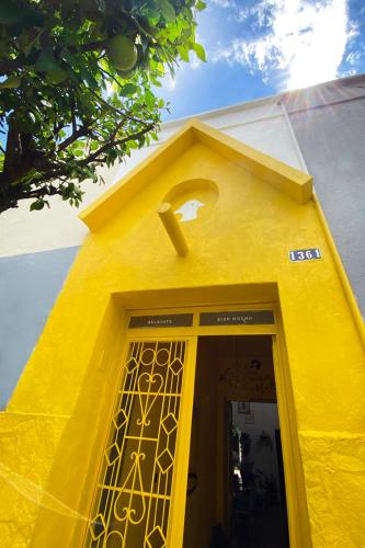 a yellow door with a number one above it at Casa Canario Hostel in Guadalajara