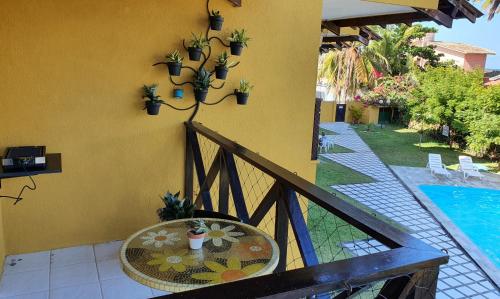 a table on a balcony next to a pool at Condomínio Merepe Residence Duplex in Porto De Galinhas