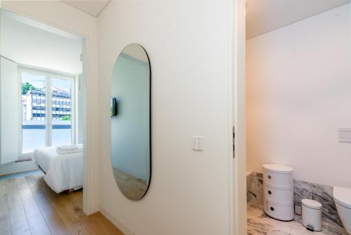 a bathroom with a mirror on the wall at Liberdade 12 by The Good Neighbour in Lisbon in Lisbon