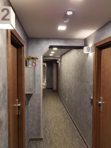 a hallway with a hallway leading into a room at Snow White apartments in Kopaonik