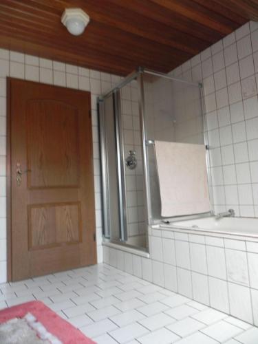 a bathroom with a shower and a glass door at sonja in Ditzum