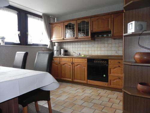 a kitchen with wooden cabinets and a stove at sonja in Ditzum