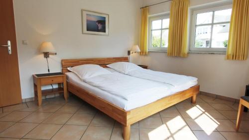 ゲーレンにある4 Sterne Dünenhausのベッドルーム1室(ベッド1台、窓2つ付)