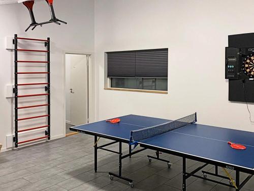 a ping pong table in the middle of a room at 16 person holiday home in V ggerl se in Marielyst