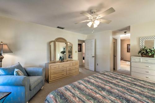 Un dormitorio con una cama, un sofá y un espejo. en Canalfront Home with Private Dock - 5 Mi to Beaches!, en Englewood