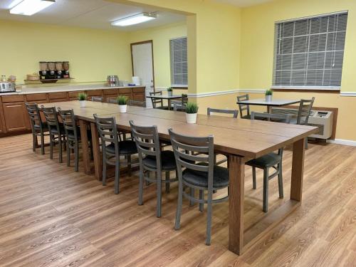 a conference room with a large wooden table and chairs at Seven Gables Inn in Branson