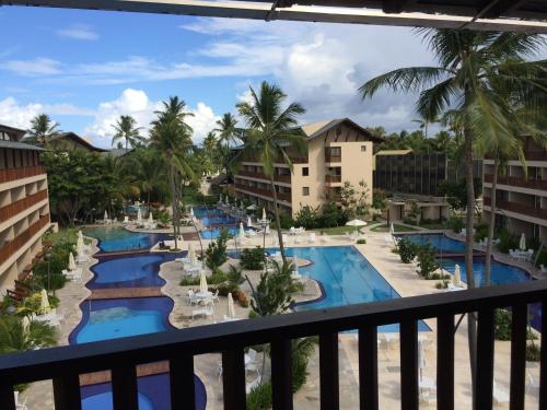 a view of the pool from the balcony of a resort at Flats no Nannai Residence - Muro Alto - Porto de Galinhas - Brasil in Porto De Galinhas