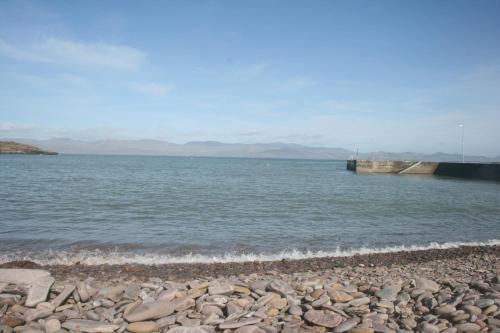 a body of water with rocks on the shore at Tigh Cladach in Cahersiveen